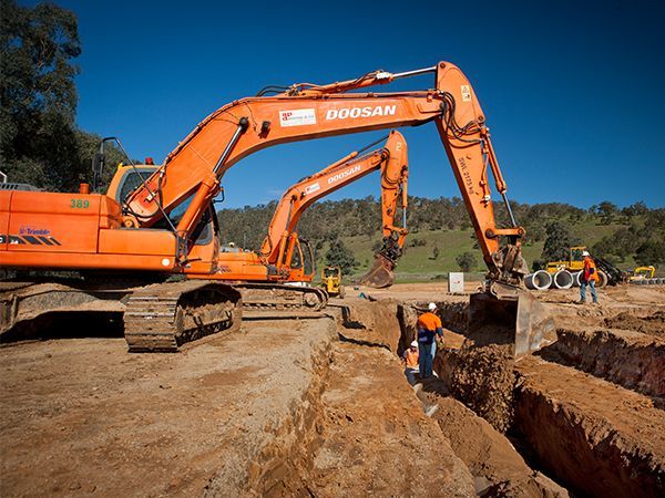 Two doosan excavators are working on a construction site