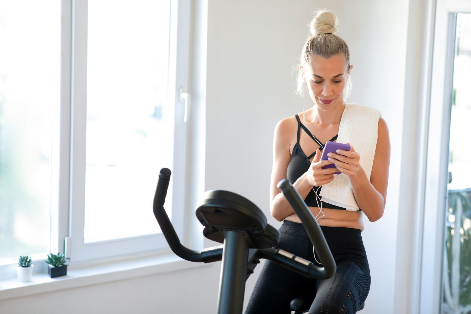 Photo of woman riding spin bike