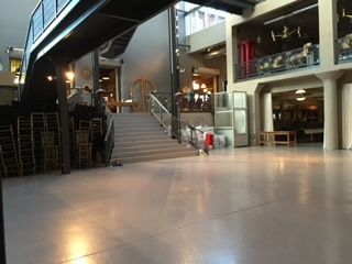 A large empty building with stairs leading up to the second floor.