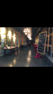 A long hallway with tables and chairs in it