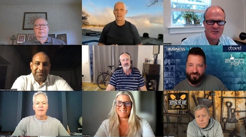Two women in an office; one showing documents while the other holds a mug, smiling.