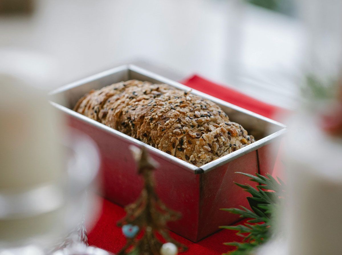 A loaf of bread is sitting in a pan on a table.