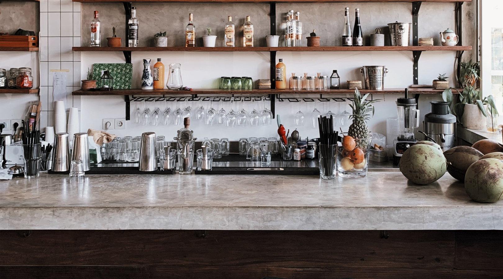 A kitchen counter with a lot of bottles on it