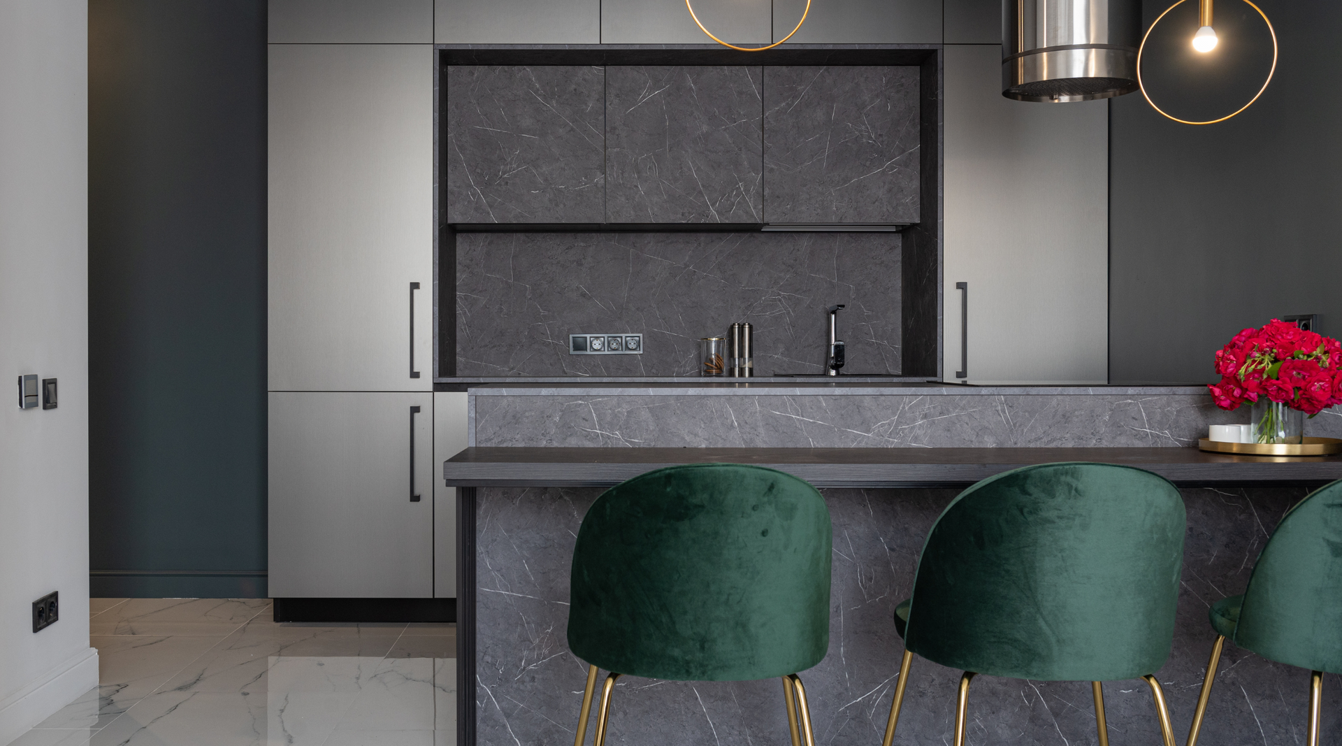 A kitchen with a bar and green chairs in it.