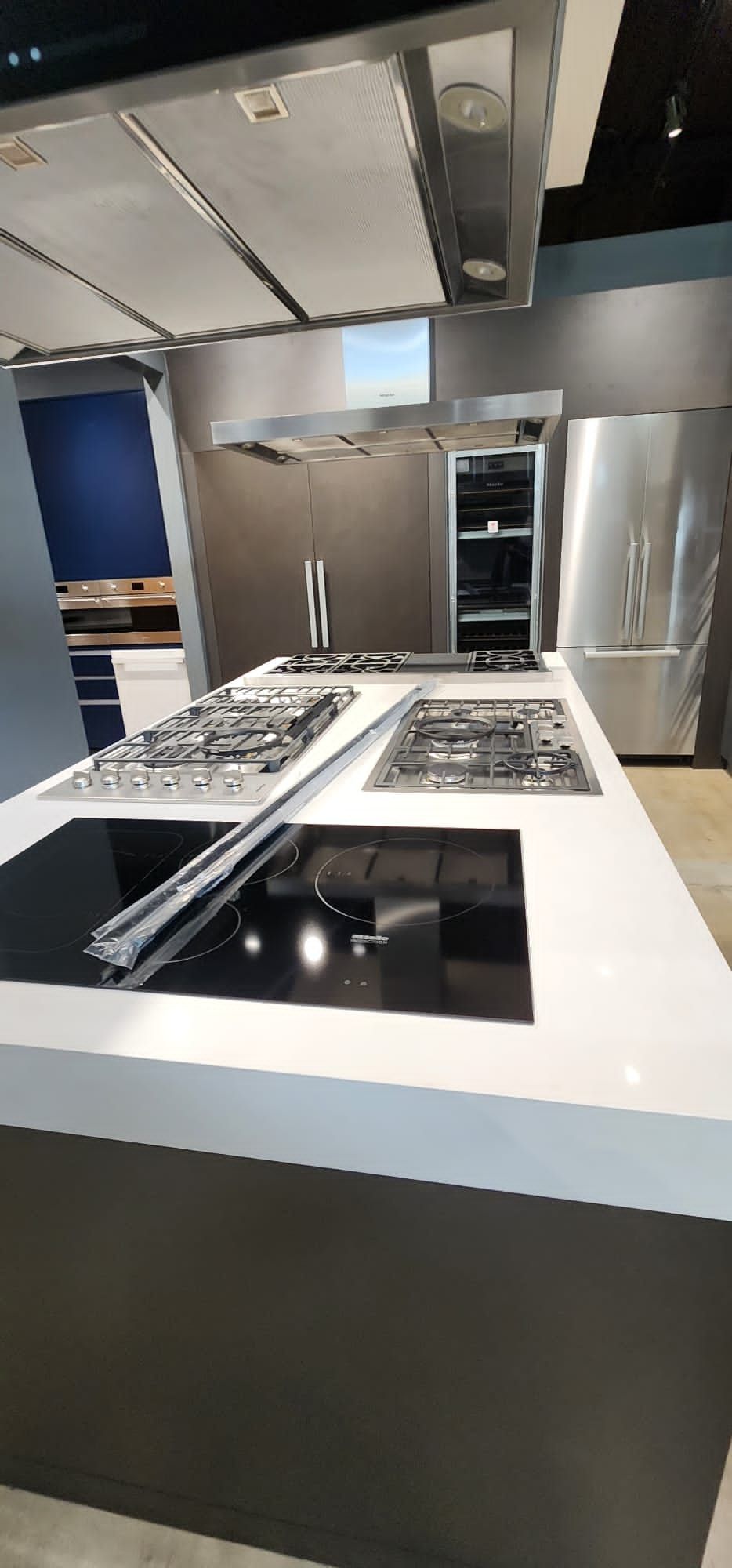 A kitchen with a lot of appliances and a stove top oven.