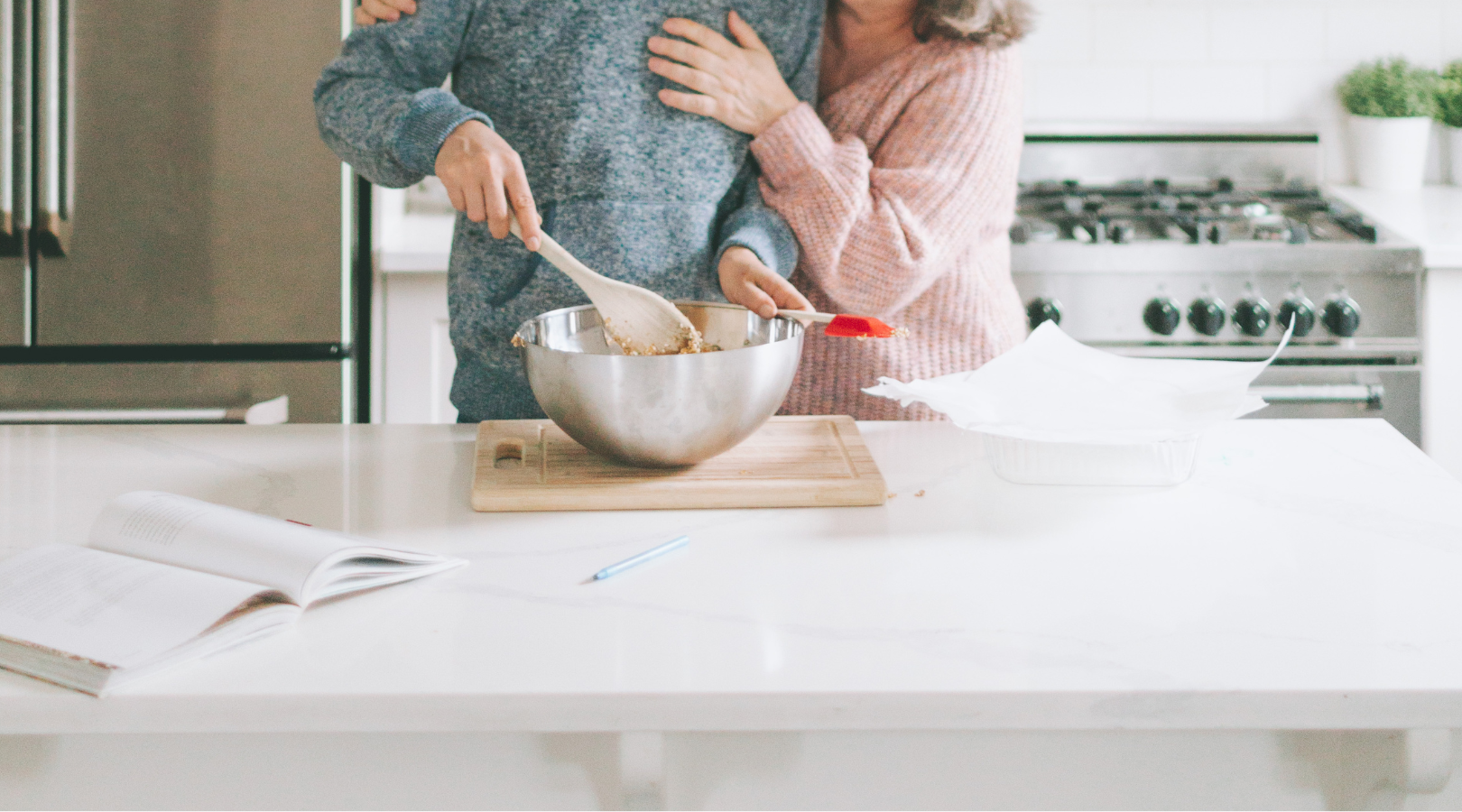 A man and a woman are preparing food in a kitchen.