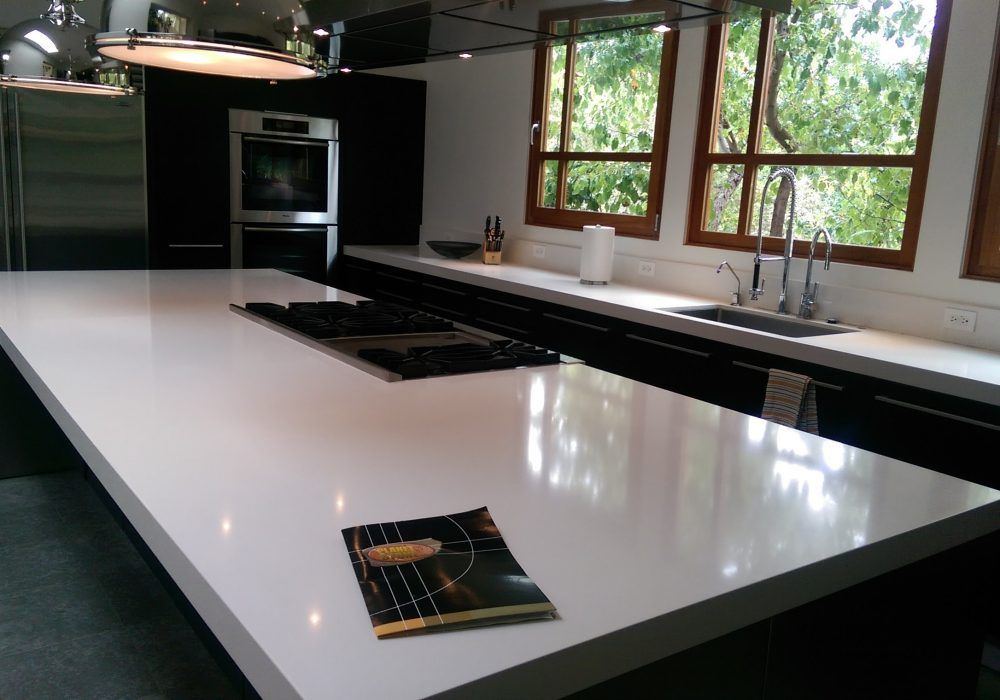 A kitchen with a stove top oven and a sink