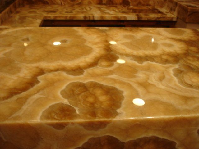 A bathroom sink with a marble counter top
