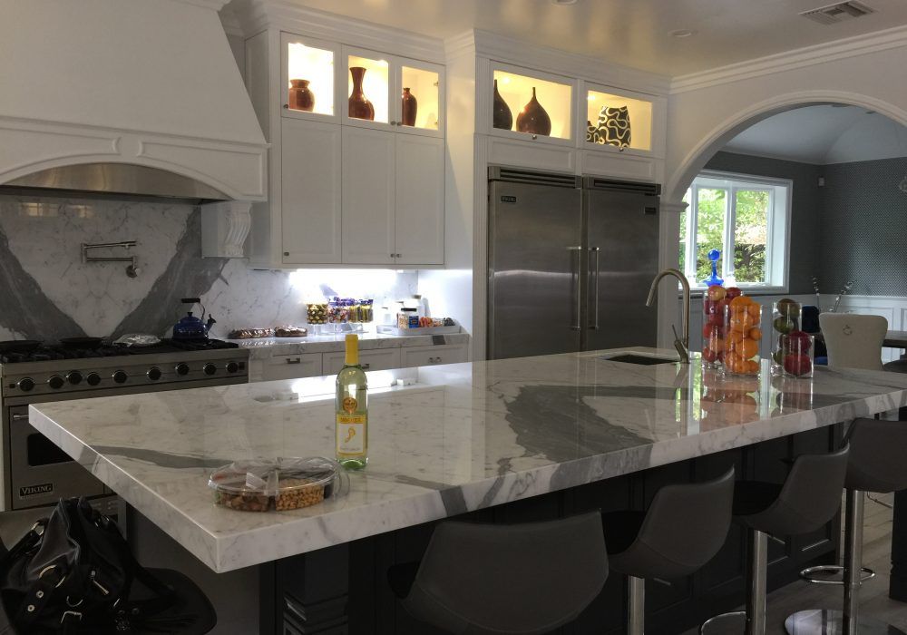 A kitchen with a large island and stainless steel appliances