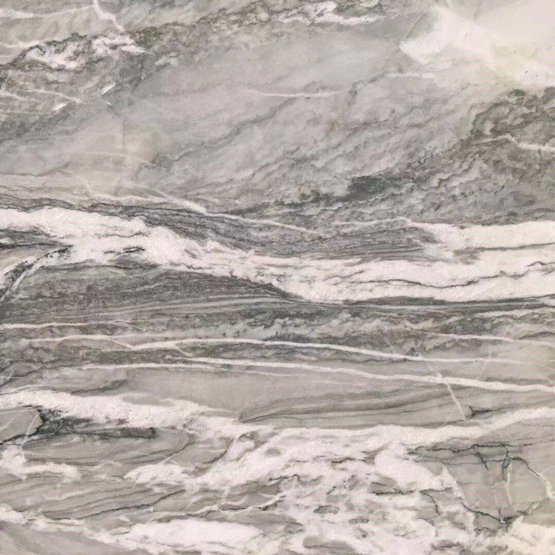 A close up of a gray and white marble counter top.