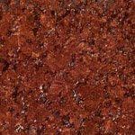 A close up of a red granite counter top.