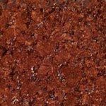 A close up of a red granite counter top.