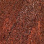 A close up of a red granite counter top.