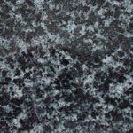 A close up of a black and white granite texture.