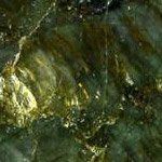 A close up of a green and gold marble texture.
