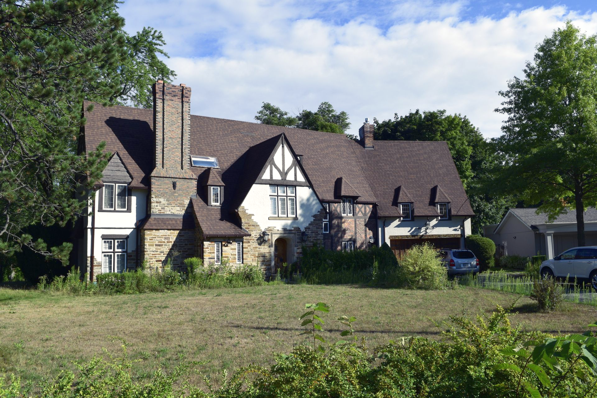 Large Tudor-style house with white walls and dark timber framing