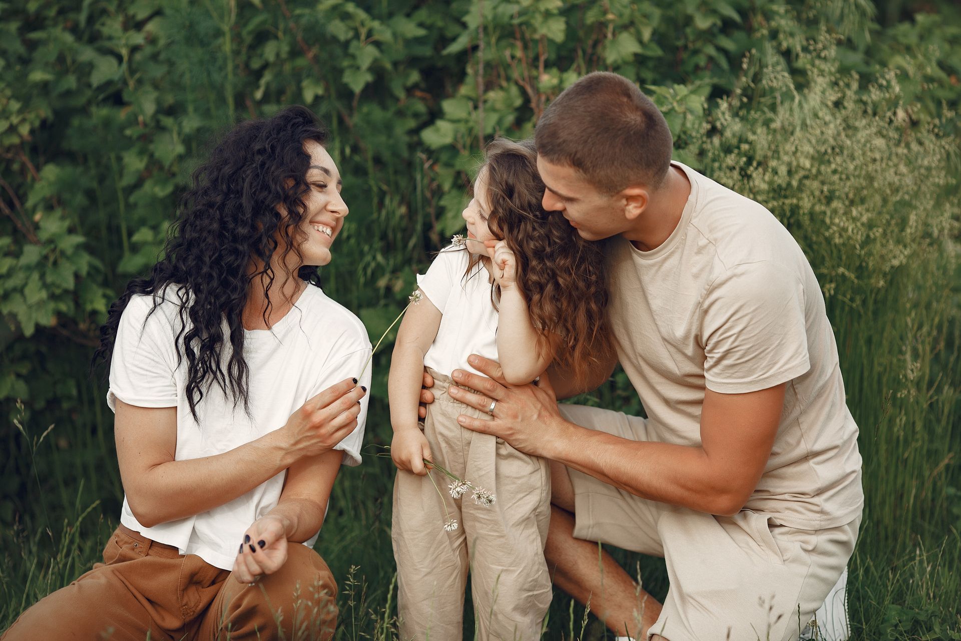 Man shows older man tablet while cooking in kitchen.