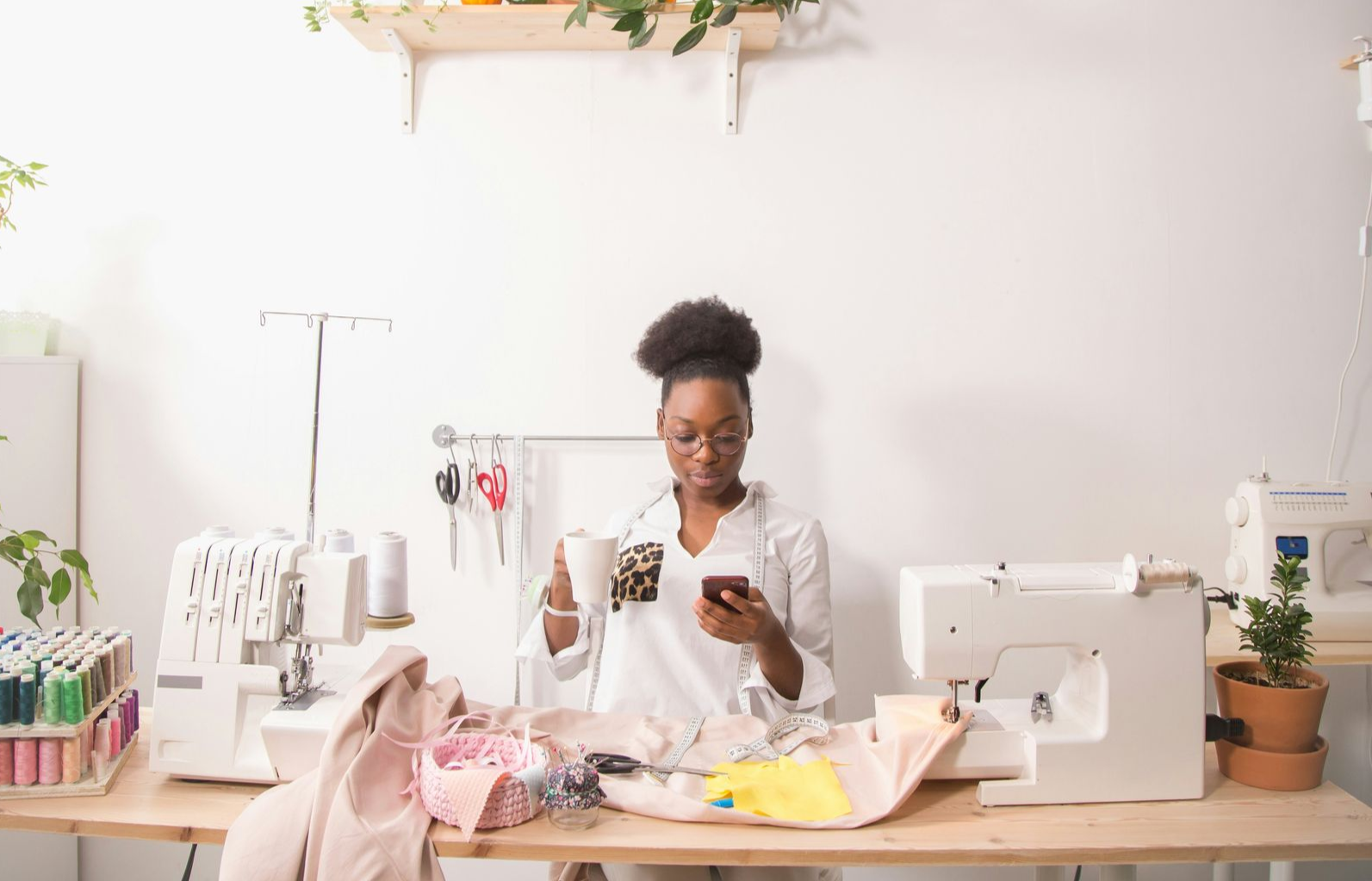 Man shows older man tablet while cooking in kitchen.