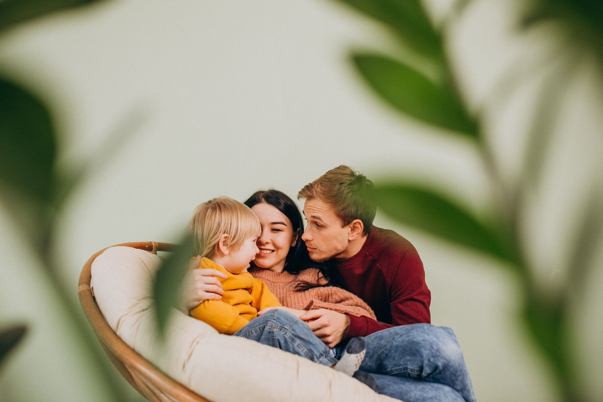 Man shows older man tablet while cooking in kitchen.