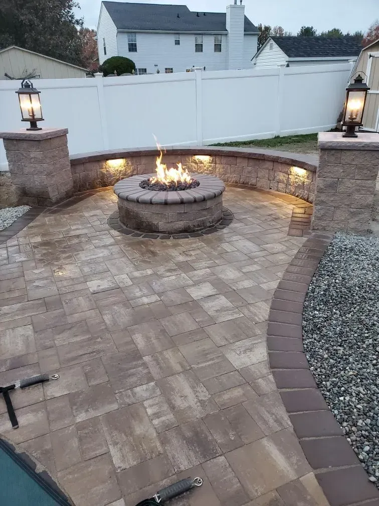 There is a fire pit in the middle of the patio.