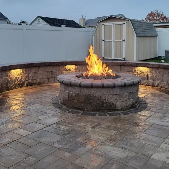 There is a fire pit in the middle of the patio.