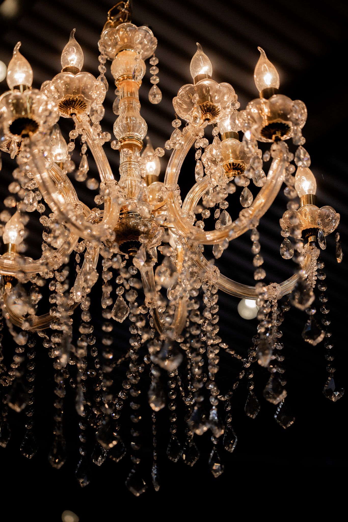 A chandelier is hanging from the ceiling in a dark room.