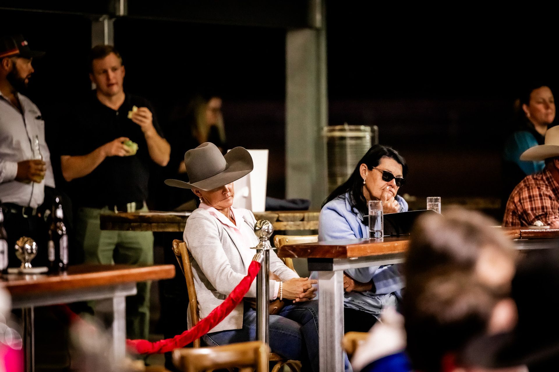 A group of people are sitting at tables in a restaurant.