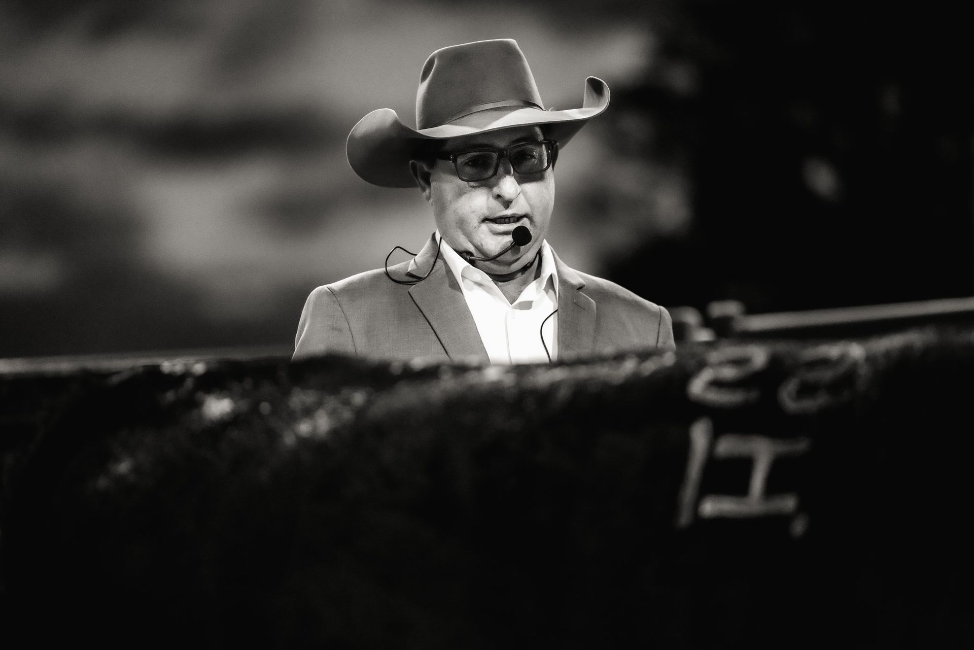 A black and white photo of a man wearing a cowboy hat