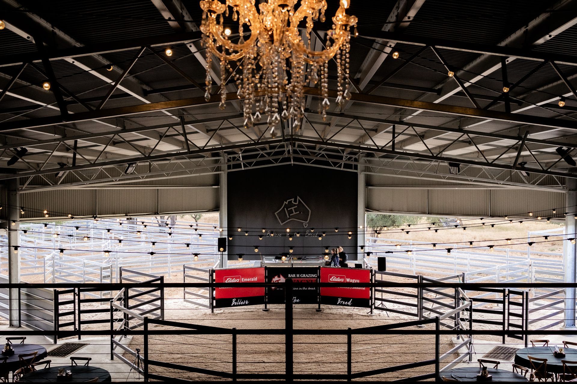 A large indoor arena with a chandelier hanging from the ceiling.