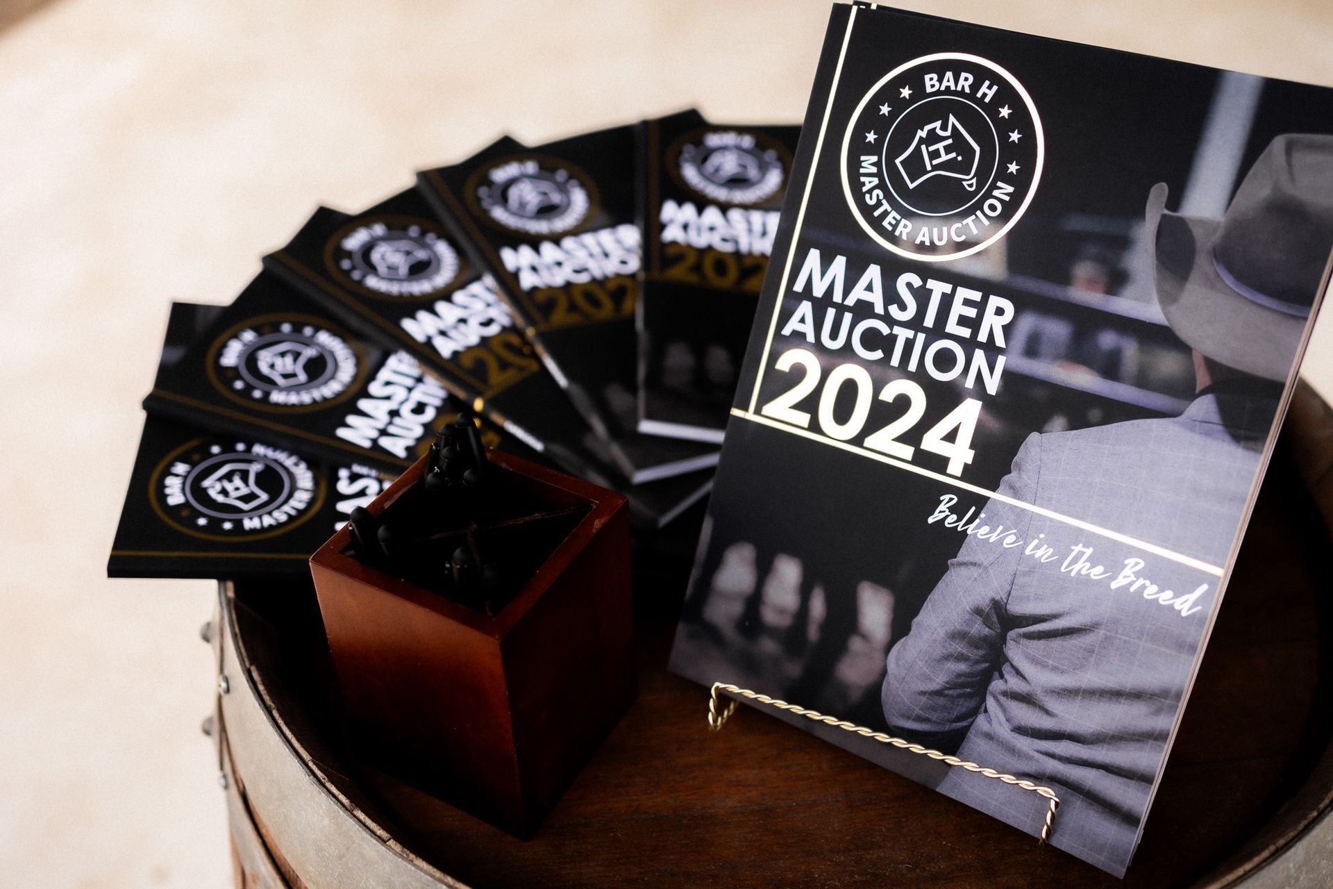 A book titled master auction 2024 is sitting on a table