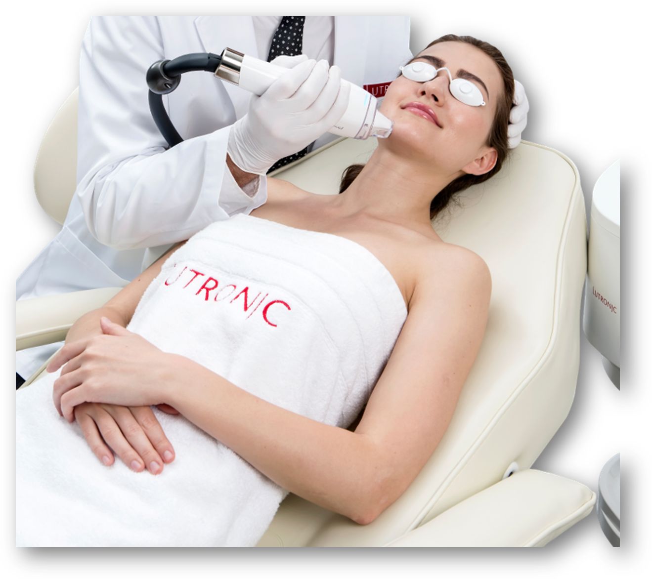 A woman is laying in a chair with a towel that says tronic on it