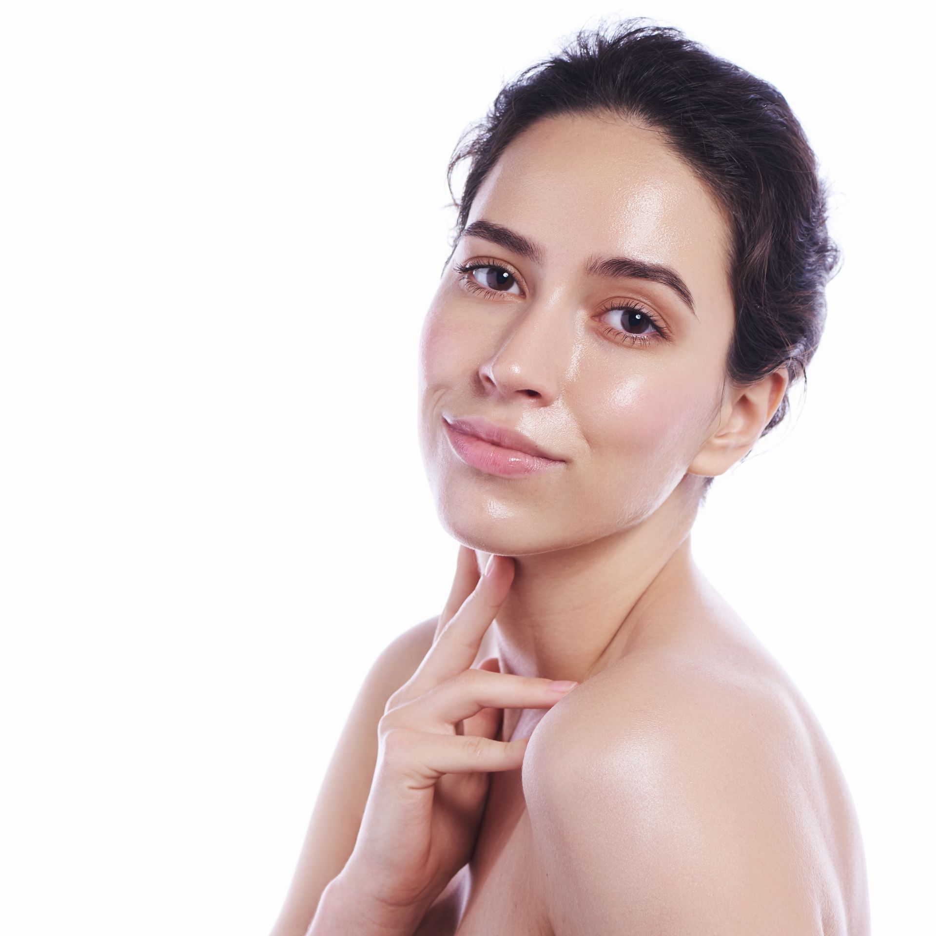 A woman touching her neck and smiling