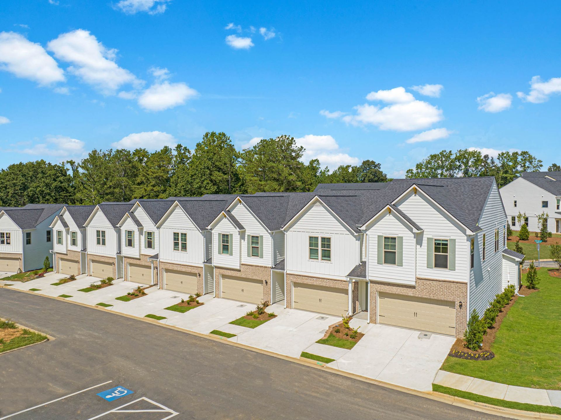 An aerial view of a row of houses with garages in a residential area at Mayridge Canton FKA Summerwalk Townhomes