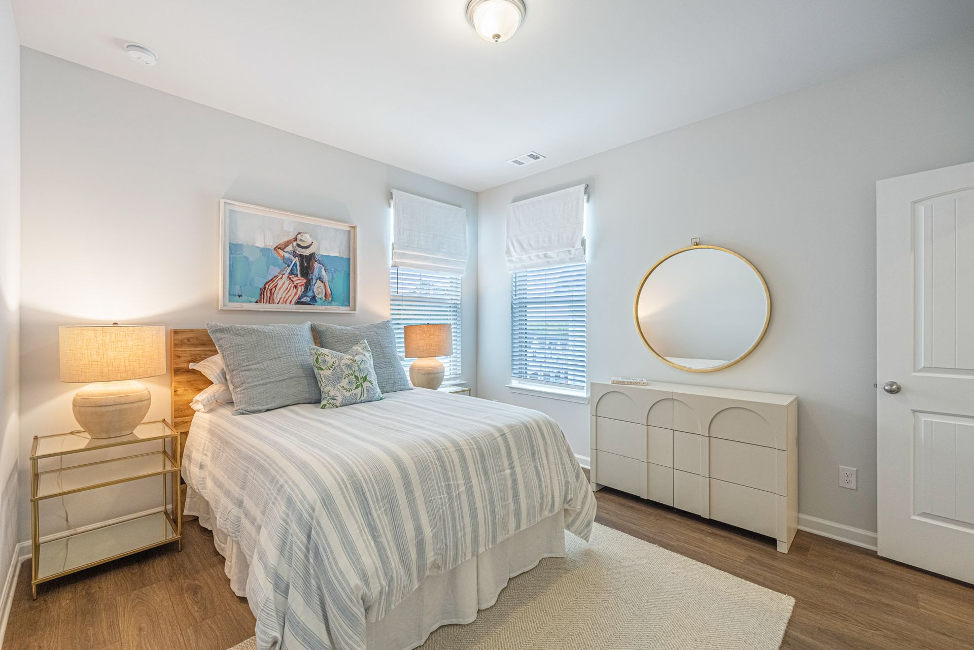 A bedroom with a bed , dresser , nightstand and mirror at Mayridge Canton FKA Summerwalk Townhomes