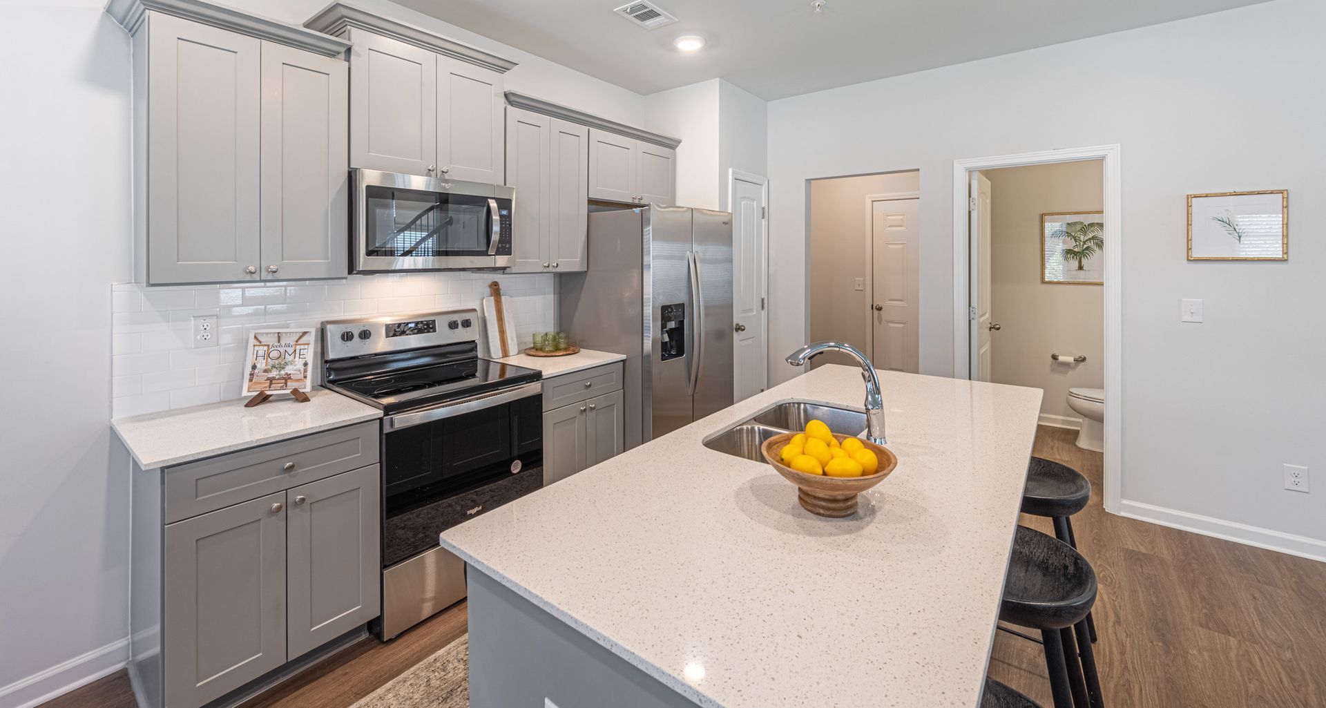 A kitchen with stainless steel appliances and granite counter at Mayridge Canton FKA Summerwalk Townhomes 