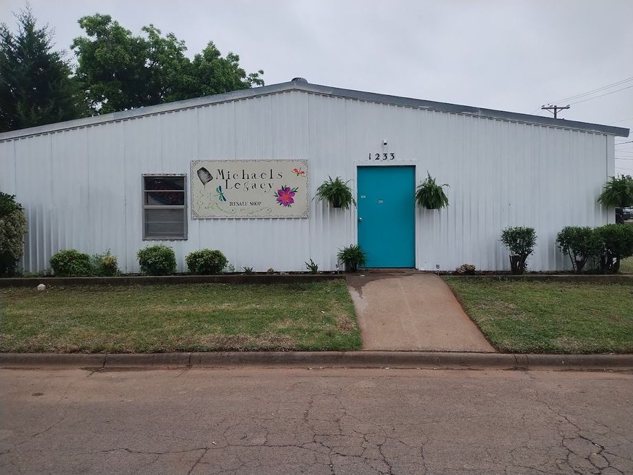 A white building with a blue door and a sign that says 1255