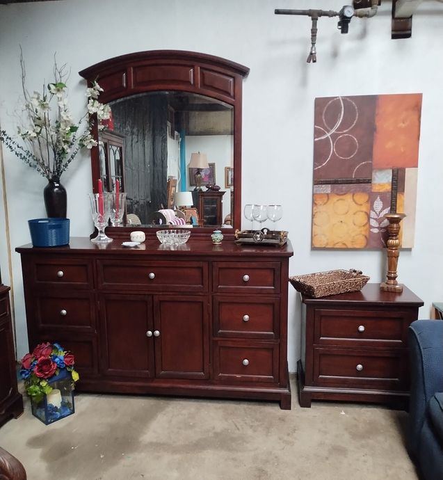 A living room with a dresser and a mirror