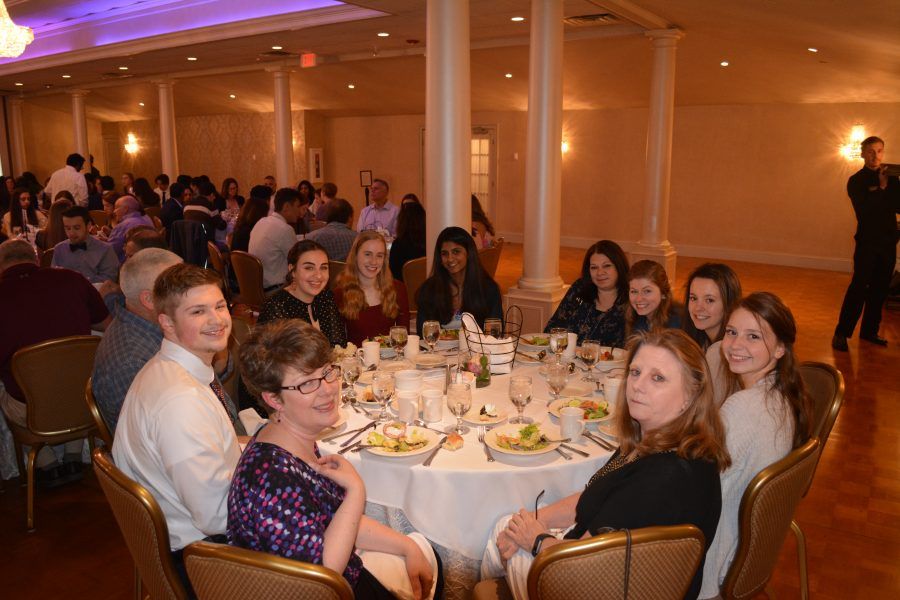 A group of people are sitting at a table in a room.