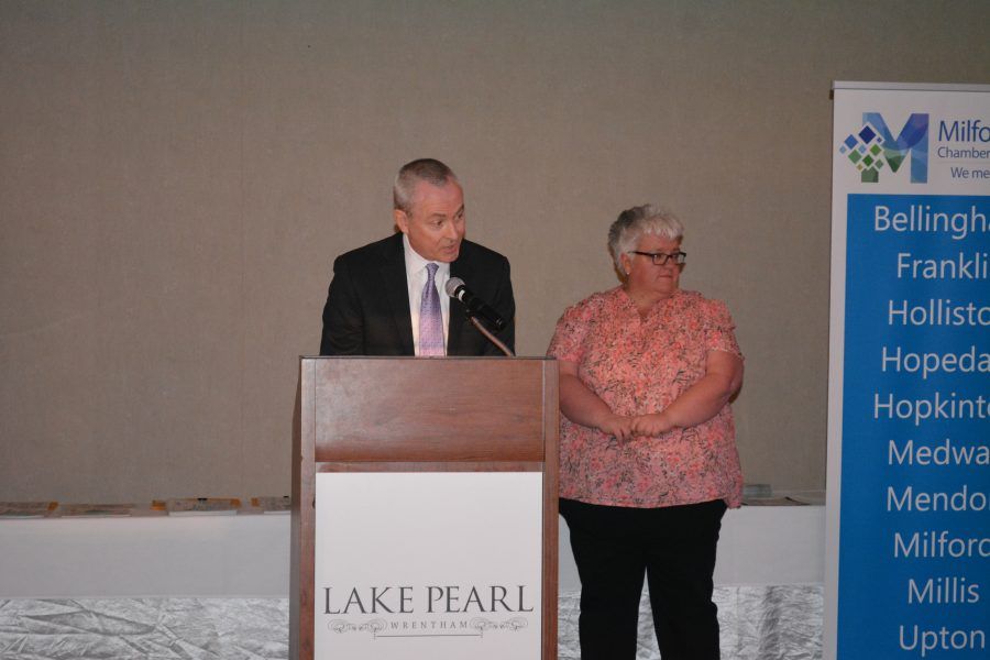 A man and woman are standing at a podium that says lake pearl