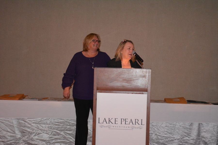 Two women standing behind a podium that says lake pearl