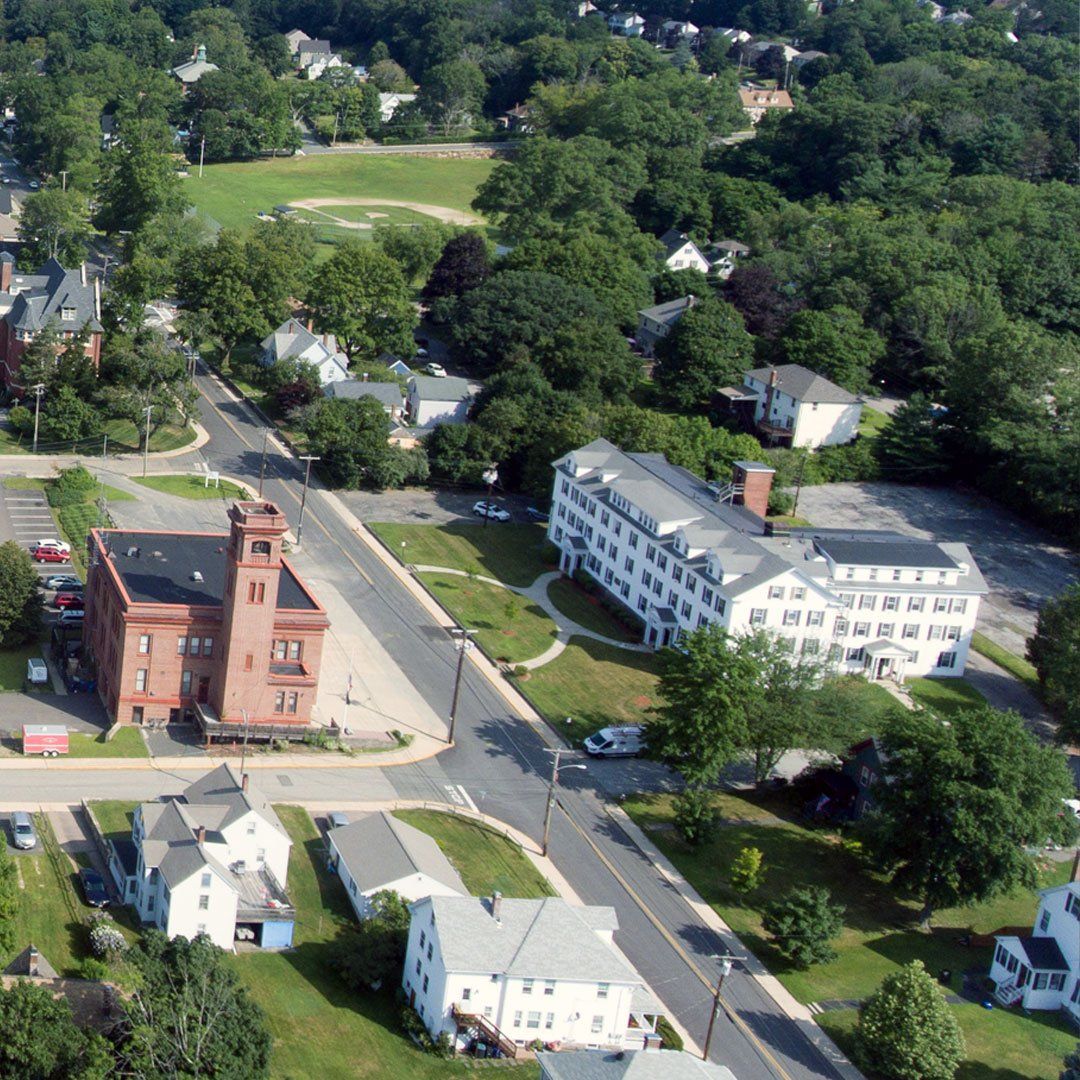 An aerial view of a small town with a red building in the middle