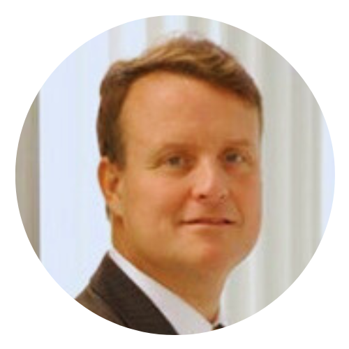 A man in a suit and tie is smiling in a circle.