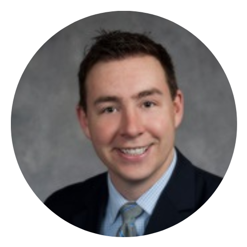 A man in a suit and tie is smiling in a circle