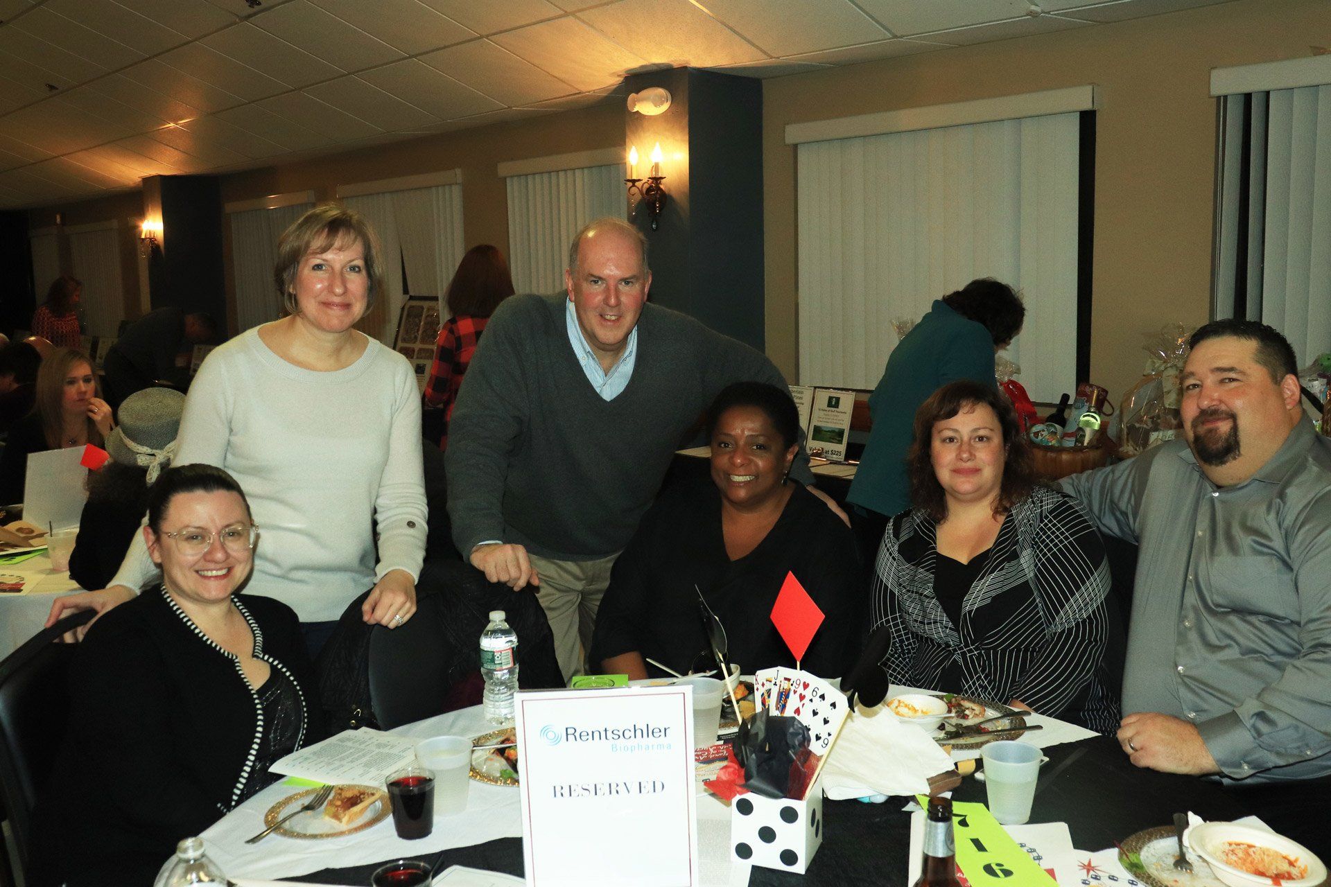 A group of people are posing for a picture at a table