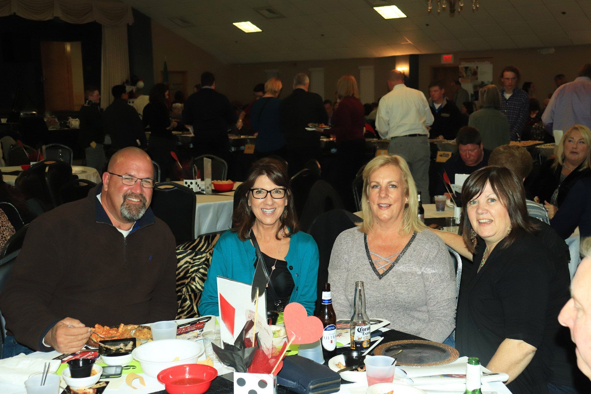 A group of people are posing for a picture at a table