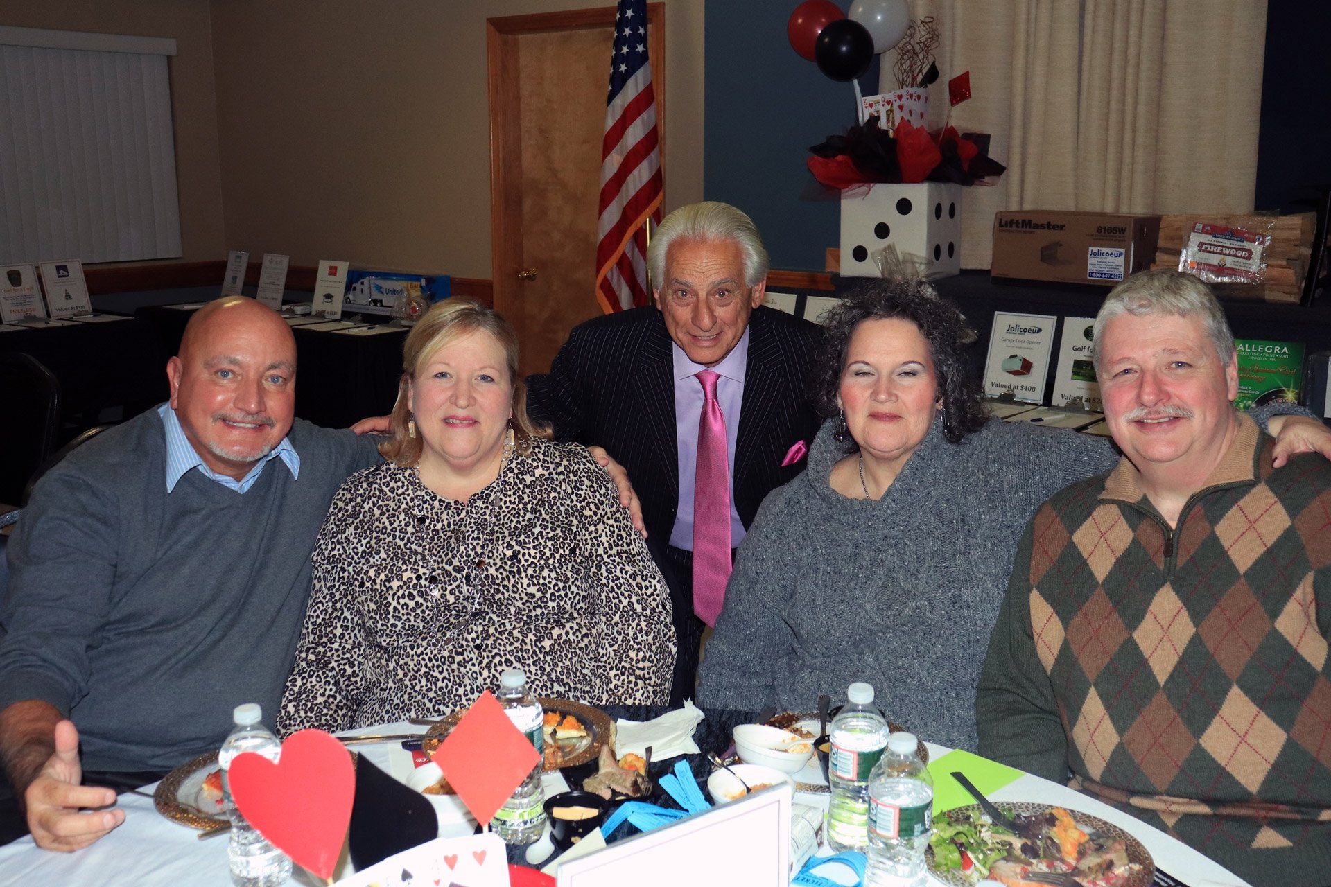 A group of people are posing for a picture at a table