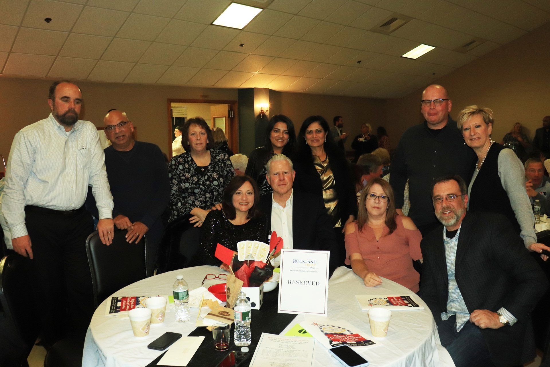 A group of people are posing for a picture at a table.