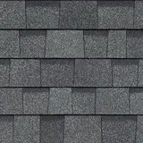 A close up of a row of gray shingles on a roof.