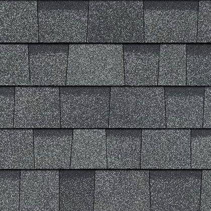 A close up of a row of gray shingles on a roof.