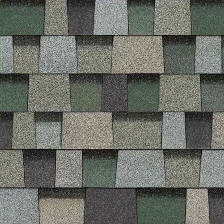 A close-up of overlapping asphalt roofing shingles in a pattern of green, gray, and dark charcoal tones.